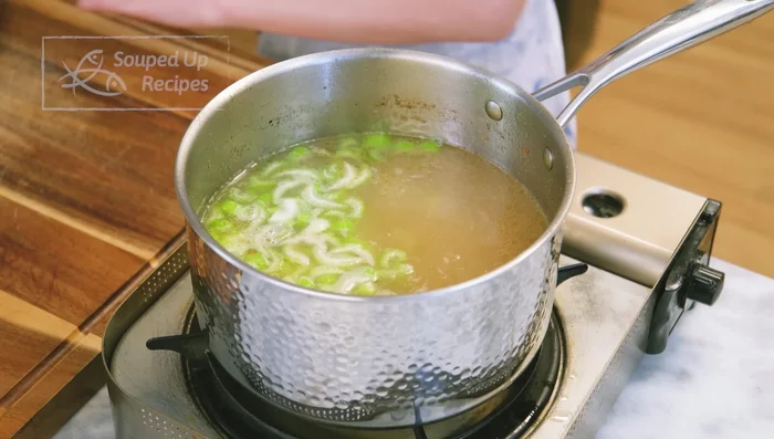 Add carrots and celery to the broth and cook for 10 minutes.