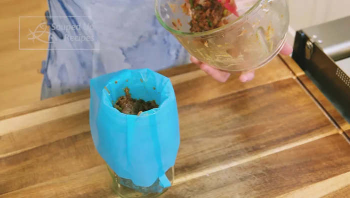 Use a piping bag with a large tip to quickly fill wonton wrappers: pipe filling onto wrapper, fold top corner, then two side corners, and pinch to seal.