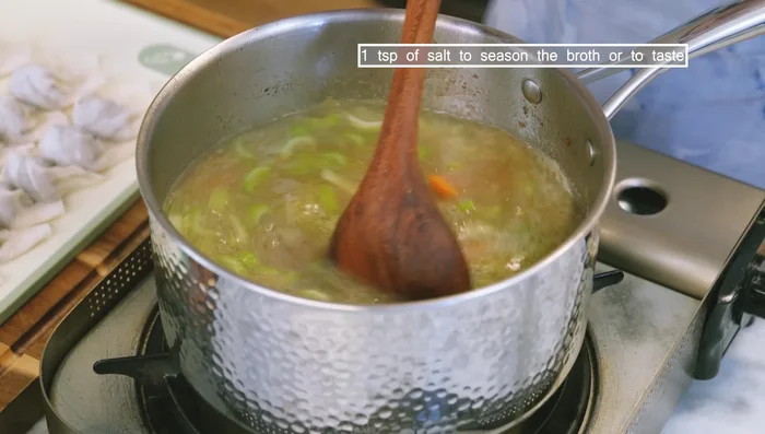 Add wontons to the broth and cook for 3 minutes. Add cold water and cook for another 3 minutes. Add baby bok choy and cook for 30 seconds.