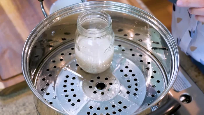 Steam the rice (without the lid) for 40 minutes. Sanitize the lid, a small bowl, and a spoon in the steamer.