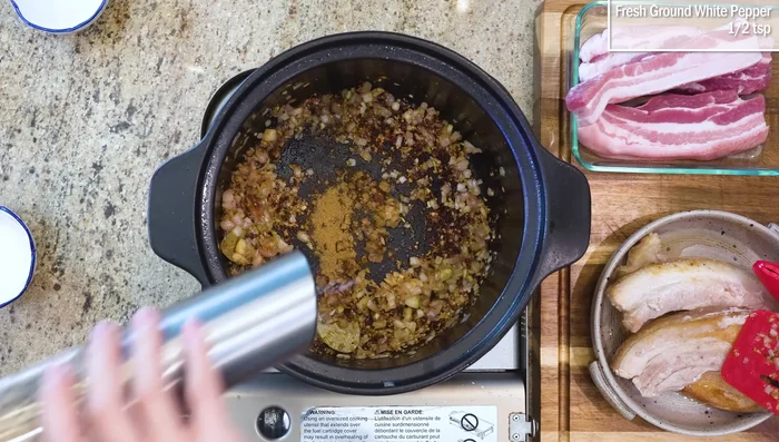 Add 5-spice powder, white pepper, sugar, cooking wine, soy sauce, and dark soy sauce. Add the seared pork and water, ensuring it’s submerged. Bring to a boil, then simmer for 1.5 hours.