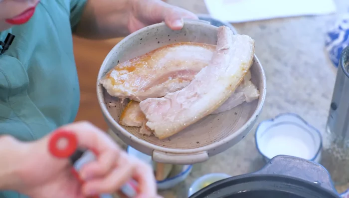 Remove pork from pot. Sauté diced shallots, minced garlic, ginger, star anise, cinnamon, and bay leaves in the remaining oil until sticky.