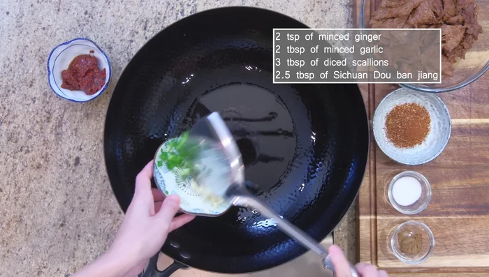In the pot, sauté ginger, garlic, scallion, and citron peppercorns until bright red.