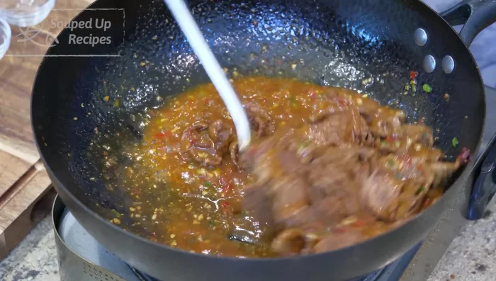 Add the poached beef and simmer for one minute. Taste and adjust seasoning.