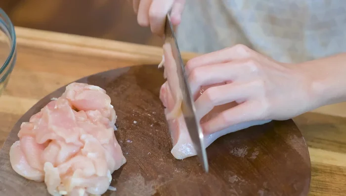 While simmering, prepare the chicken marinade: Combine chicken breast, salt, Chinese cooking wine, egg white, corn starch, and garlic powder. Mix well for 5 minutes.