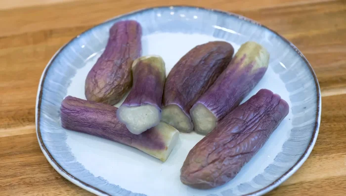 Remove eggplants from water and let cool. The purple color will become more vibrant.