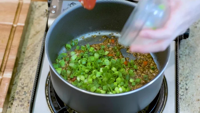 Turn off heat; stir in diced scallions. Add a splash of water if needed to adjust consistency.