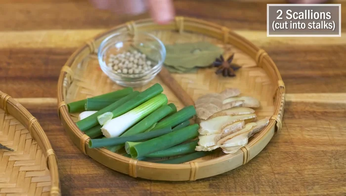 Prepare a spice bag with ginger, scallions, cinnamon, star anise, bay leaves, and white peppercorns.
