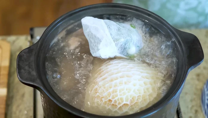 Add the spice bag to the boiling beef broth. Reduce heat to low and simmer for two hours.