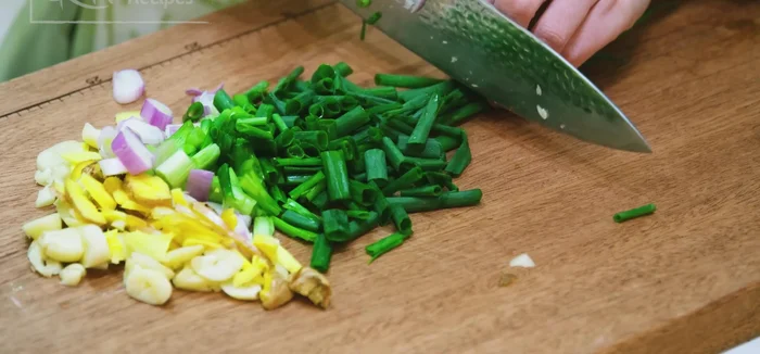 Marinate the fish with crushed garlic, ginger, and diced scallions and Chinese cooking wine.