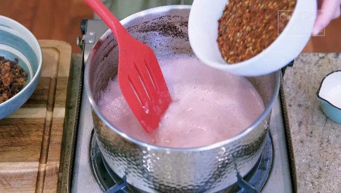 Turn off the heat. Add chili flakes and fermented black beans. Stir.