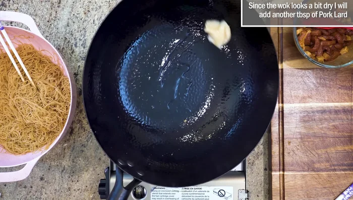 Stir-fry pork: Add more pork lard to wok. Stir-fry marinated pork until color changes.