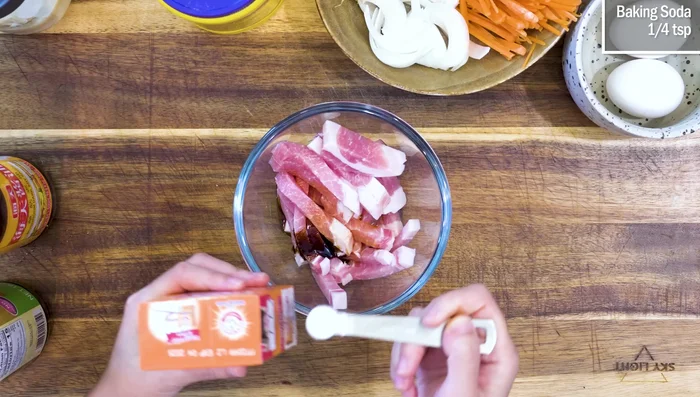Marinate the pork: Cut pork into strips. Add soy sauce, dark soy sauce, baking soda, and cornstarch. Mix well and set aside.