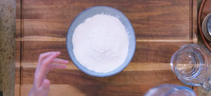 Prepare the dough: combine rice flour, tapioca flour, and salt. In a separate bowl, heat water in the microwave until boiling. Pour hot water into flour mixture and stir vigorously until a dough forms.