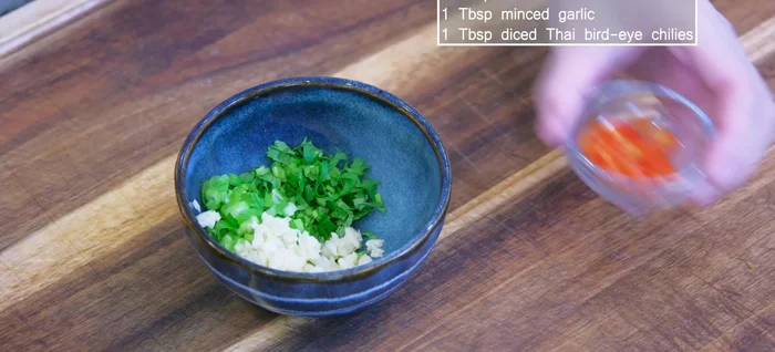 Make the dipping sauce (optional): Combine cilantro, scallions, garlic, chili, and heated cooking oil. Stir in soy sauce.