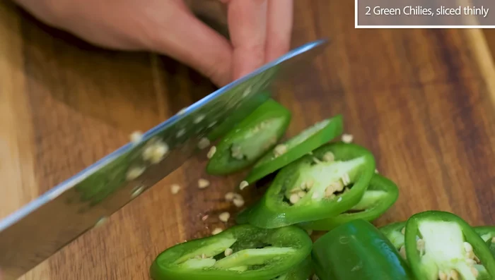Prepare aromatics: Slice chilies, garlic, ginger, and scallions (197.58).