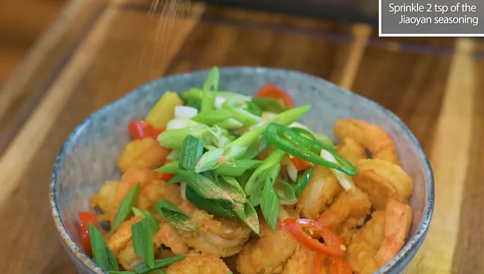 Combine and serve: Add the fried aromatics and scallions to the shrimp. Sprinkle with seasoning powder and toss (341.699). Serve immediately.