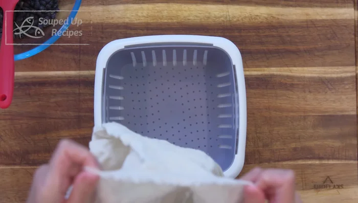 Place the beans in a cheesecloth inside your fermentation container, ensuring air circulation. Cover to retain moisture but not airtight.