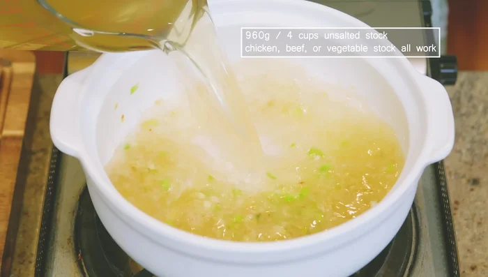 Pour in 4 cups of stock (chicken, beef, vegetable, or pork). Bring to a light simmer, then reduce heat to low.