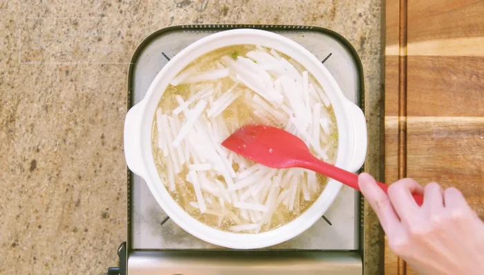 Add the julienned daikon radish. Bring to a boil and cook for 3 minutes.
