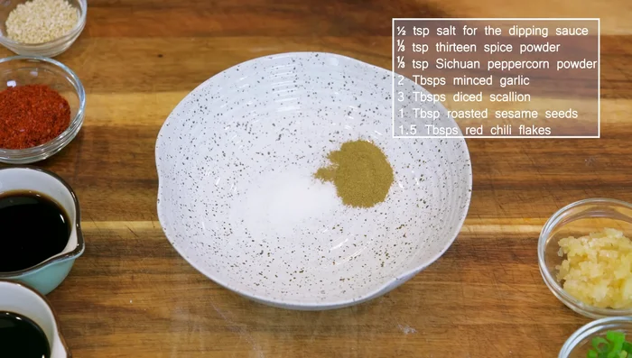 Prepare the dipping sauce (Jray): Combine 0.5 tsp salt, 3 tsp 13-spice powder (or 5-spice powder), 1/3 tsp Sichuan peppercorn powder, 2 tbsp minced garlic, 3 tbsp diced scallion, 1 tbsp roasted sesame seeds, 1.5 tbsp red chili flakes (or sweet paprika for a non-spicy version), and 3 tbsp hot cooking oil.