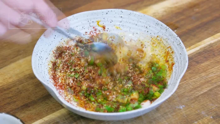 Add 3 tbsp soy sauce and 1 tbsp Chinese black vinegar to the dipping sauce, and mix well. Divide into three bowls.