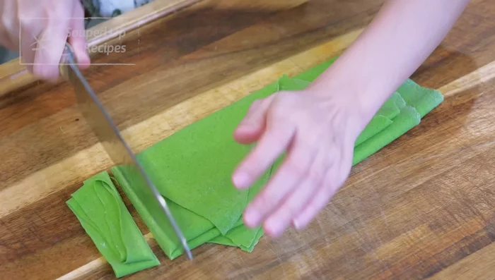 Fold the sheet, then cut into 1-inch wide ribbons (belt noodles).