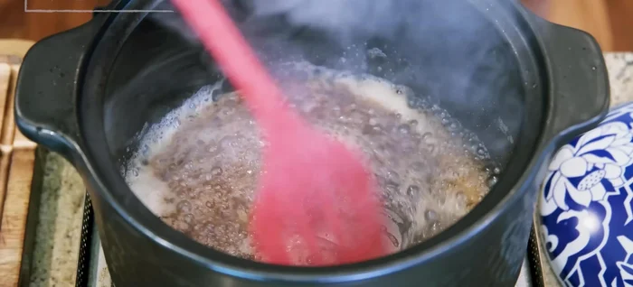 Add soy sauce, stir, then add sanang, tomato paste, and dark soy sauce. Mix well.