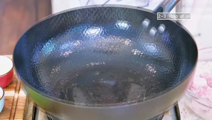 Preheat wok, add oil, and sear ribs over high heat until slightly charred (1-2 minutes).