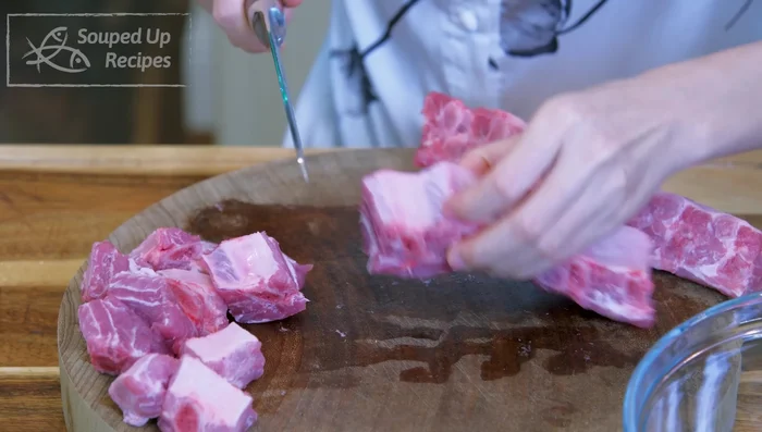 Cut pork ribs into 1-inch thick strips, between the bones.