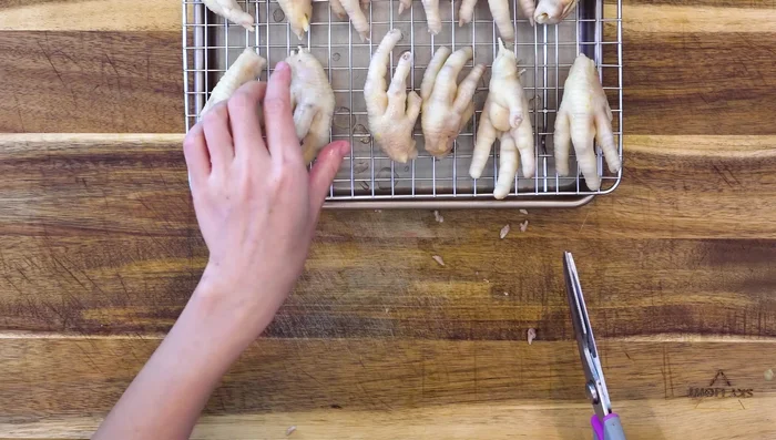 Cool and trim: Transfer chicken feet to a rack to cool. Once lukewarm, trim the nails with kitchen scissors.