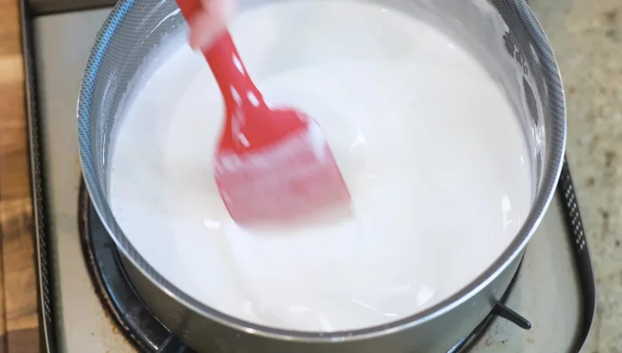 When starch clumps form, remove from heat and incorporate them back into the mixture until smooth. Repeat this process, removing from heat each time large starch clumps form, to ensure even consistency. Avoid overheating, which can lead to uneven texture.