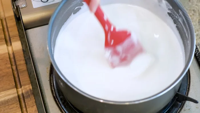 Continue heating and stirring until the mixture thickens. The mixture should lift up and fall off the spatula in a single, swinging chunk. This indicates the perfect consistency for piping.
