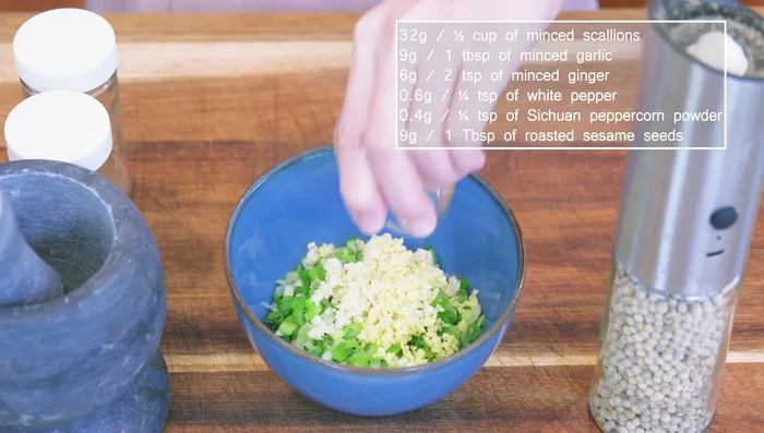 Make the filling: Mince aromatics (scallions, garlic, ginger), season with white pepper, sichuan peppercorn powder, and sesame seeds. Heat oil and pour over aromatics. Mix with minced pork, salt, sugar, soy sauce, and minced Jell-O.