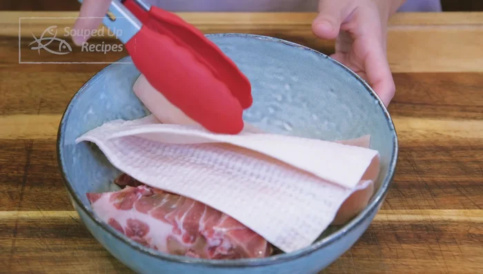 Prepare the broth (long method): Combine pork skin, neck bones, ginger, scallions, ham/prosciutto, and water. Boil, discard water, rinse ingredients, and simmer for 3 hours.
