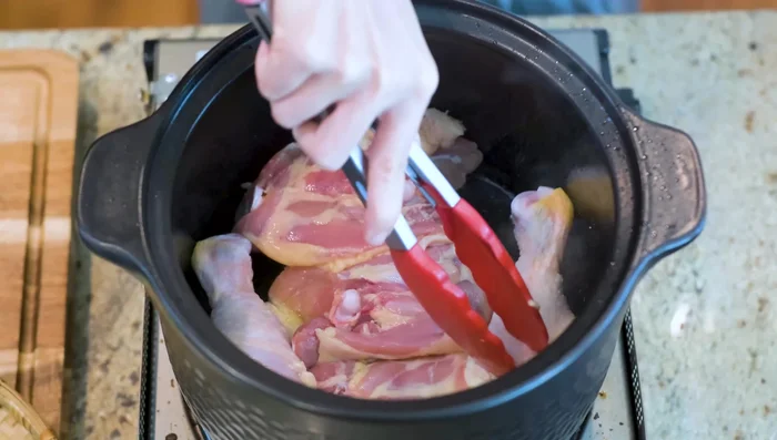 Add chicken, skin-side down, and sear until golden brown (a few minutes per side). Add a small piece of jingkwa (optional) for extra umami.