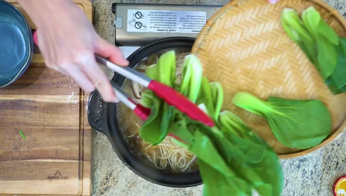 Add bok choy to the soup during the last 30 seconds of cooking. Season with salt to taste.