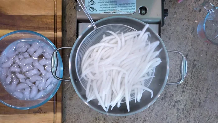 Immediately transfer the noodles to an ice bath to retain their chewy texture.