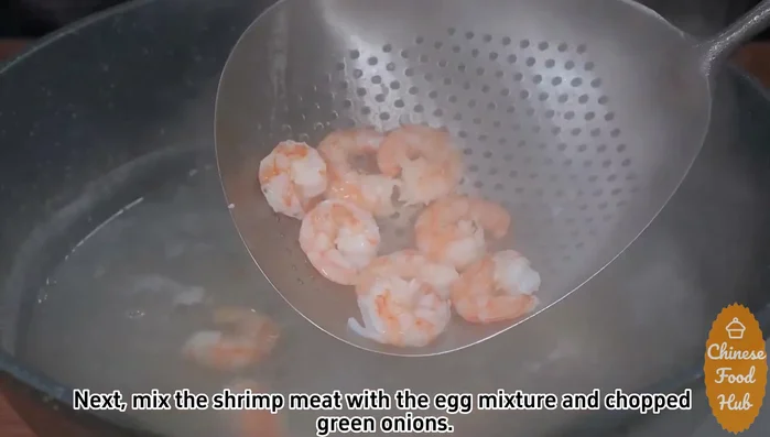 Combine ingredients: Mix the cooked shrimp with the egg mixture and chopped green onions.