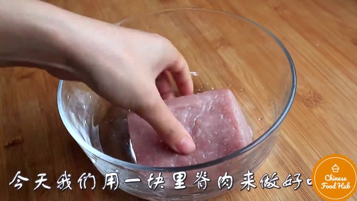 Prepare the pork by slicing it into thin pieces. (This step's details are missing from the transcript)