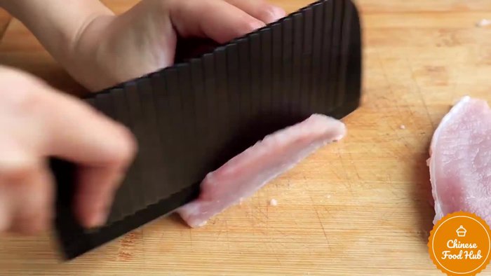 Marinate the pork (the transcript doesn't provide specifics on the marinade)
