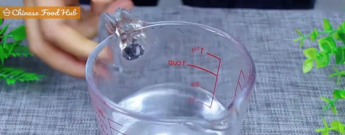 Prepare yeast mixture: Combine warm water, dry yeast, and sugar. Stir until yeast dissolves. (11.36)