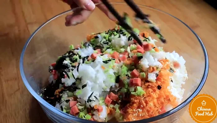 Once the rice is cooked and cooled slightly, mix in the cheese and vegetables.