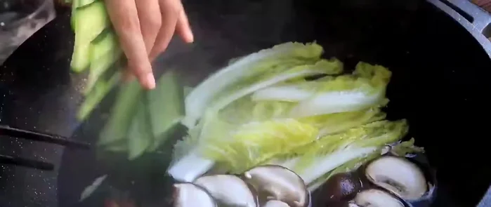 Gently add the shrimp balls to the boiling soup.