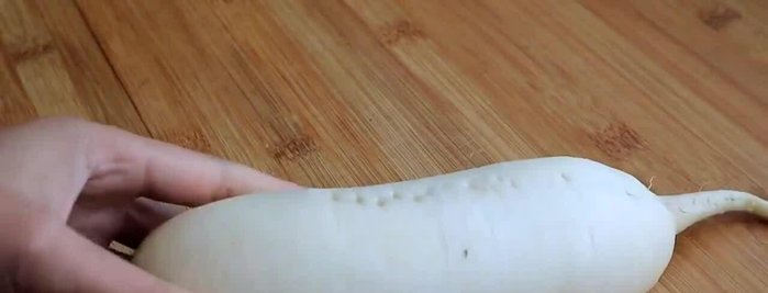 Prepare the daikon radish by peeling and grating it.