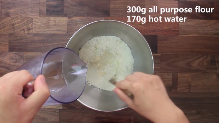 Begin by preparing the dough. Combine flour and boiling water to form a smooth dough. The exact amounts will depend on your desired pancake size.