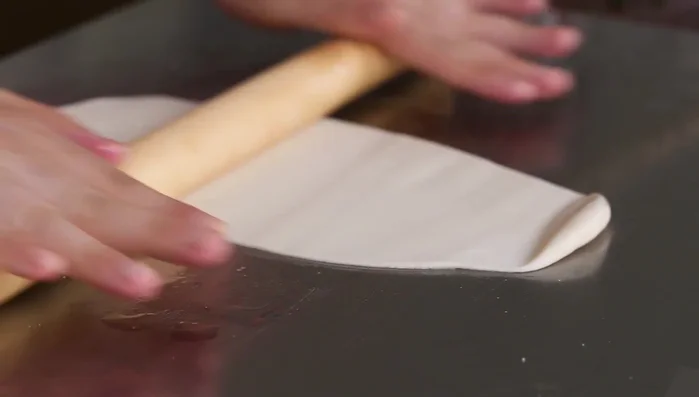 Sprinkle the chopped scallions evenly over the dough.