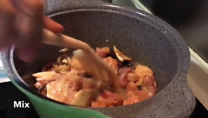 Add soy sauce and rock sugar. Stir well to coat the pork belly (Note: Specific amounts and stirring technique are missing from the transcript)