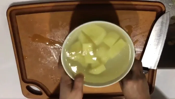 In a pot, heat cooking oil and then sear the pork belly until lightly browned. (Note: Details about oil temperature and searing time are missing from the transcript)