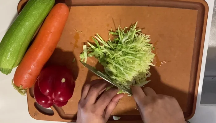 Create the batter: In a separate bowl, whisk together the egg and water. Gradually add the wet ingredients to the dry ingredients, mixing until a smooth batter forms. (Note: No precise measurements provided in the audio.)